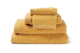 Modern cotton towel in a yellow ochre from the « Como » collection
